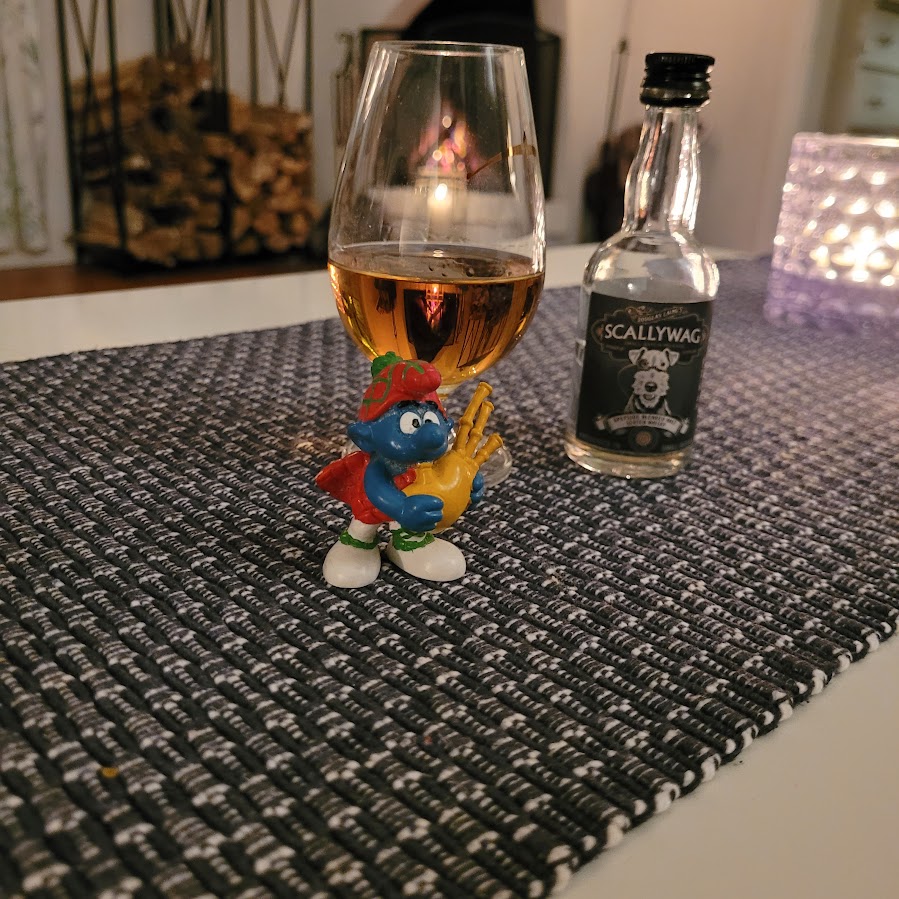 20260228_184126 Scallywag blended malt whisky i glas framför brasa